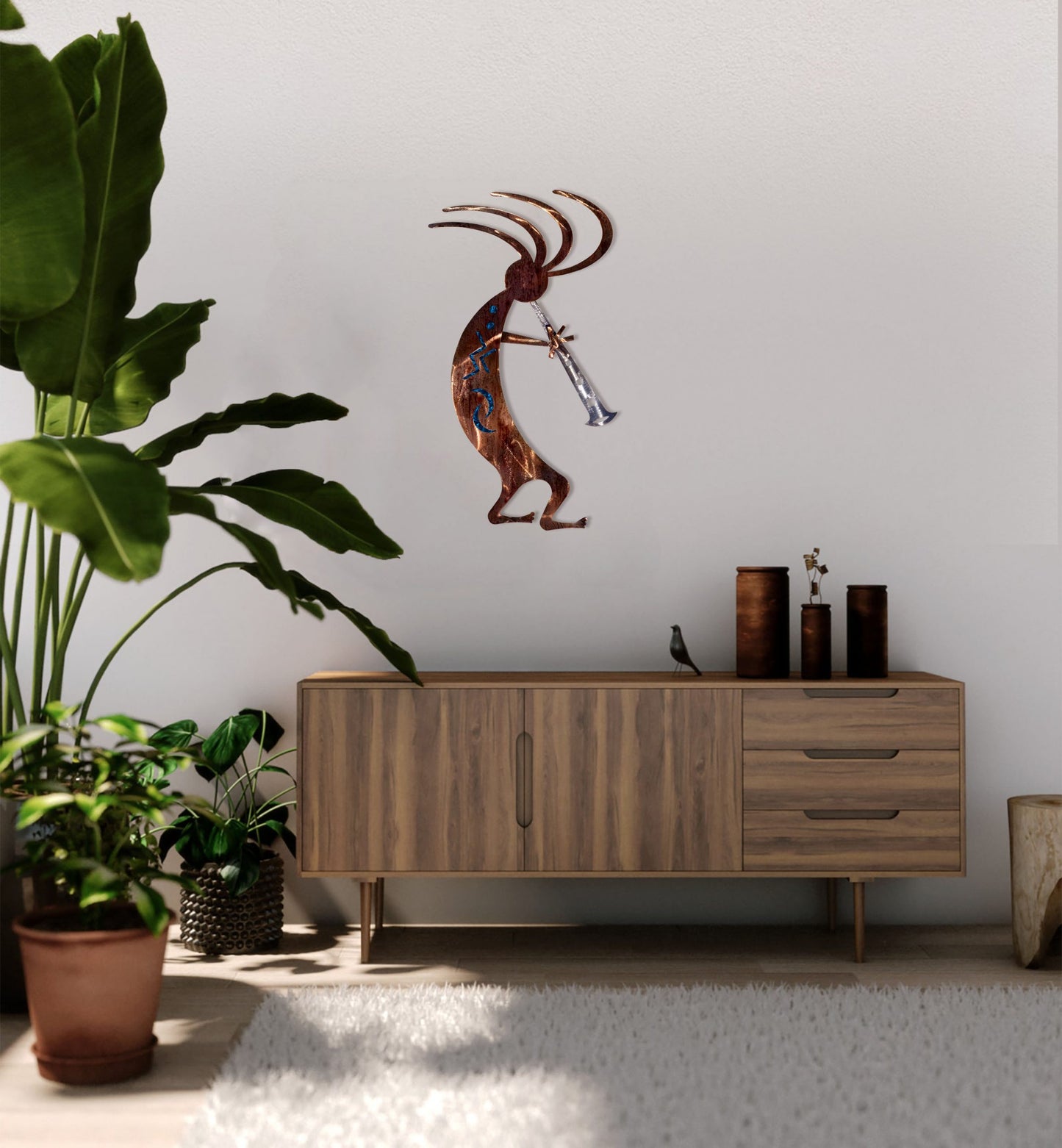 blue-kokopelli-dancer-near-plant-scaled